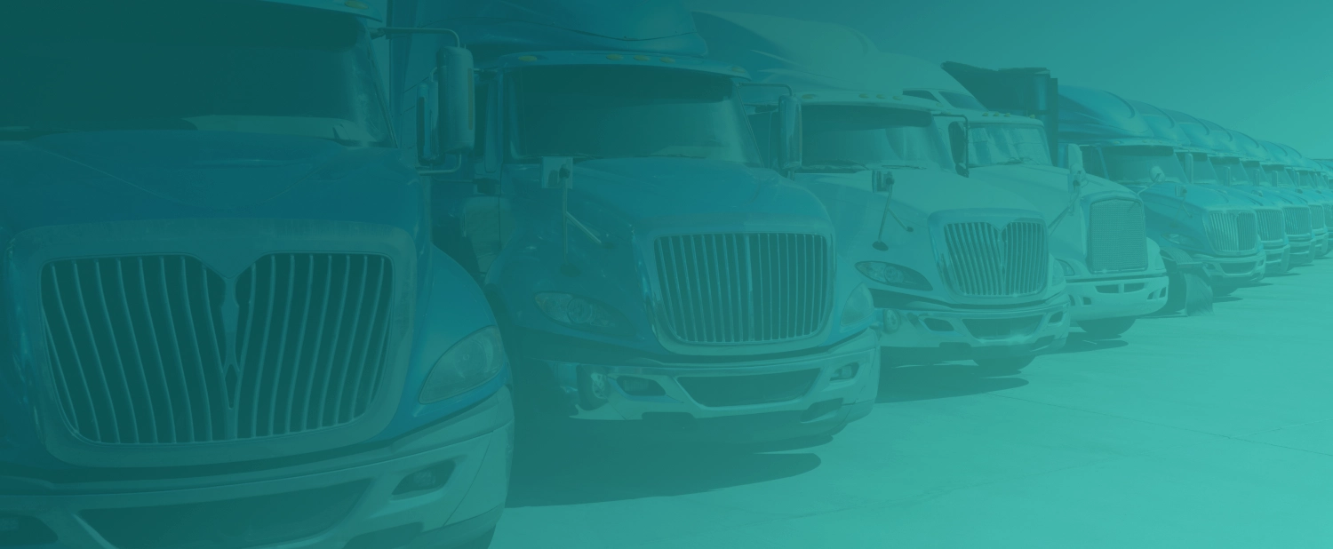 Row of semi trucks parked side by side, seen from the front